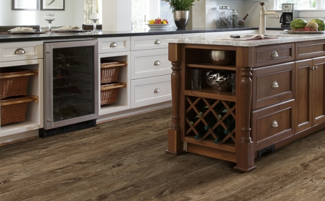 Kitchen with luxury vinyl flooring with wood cabinets